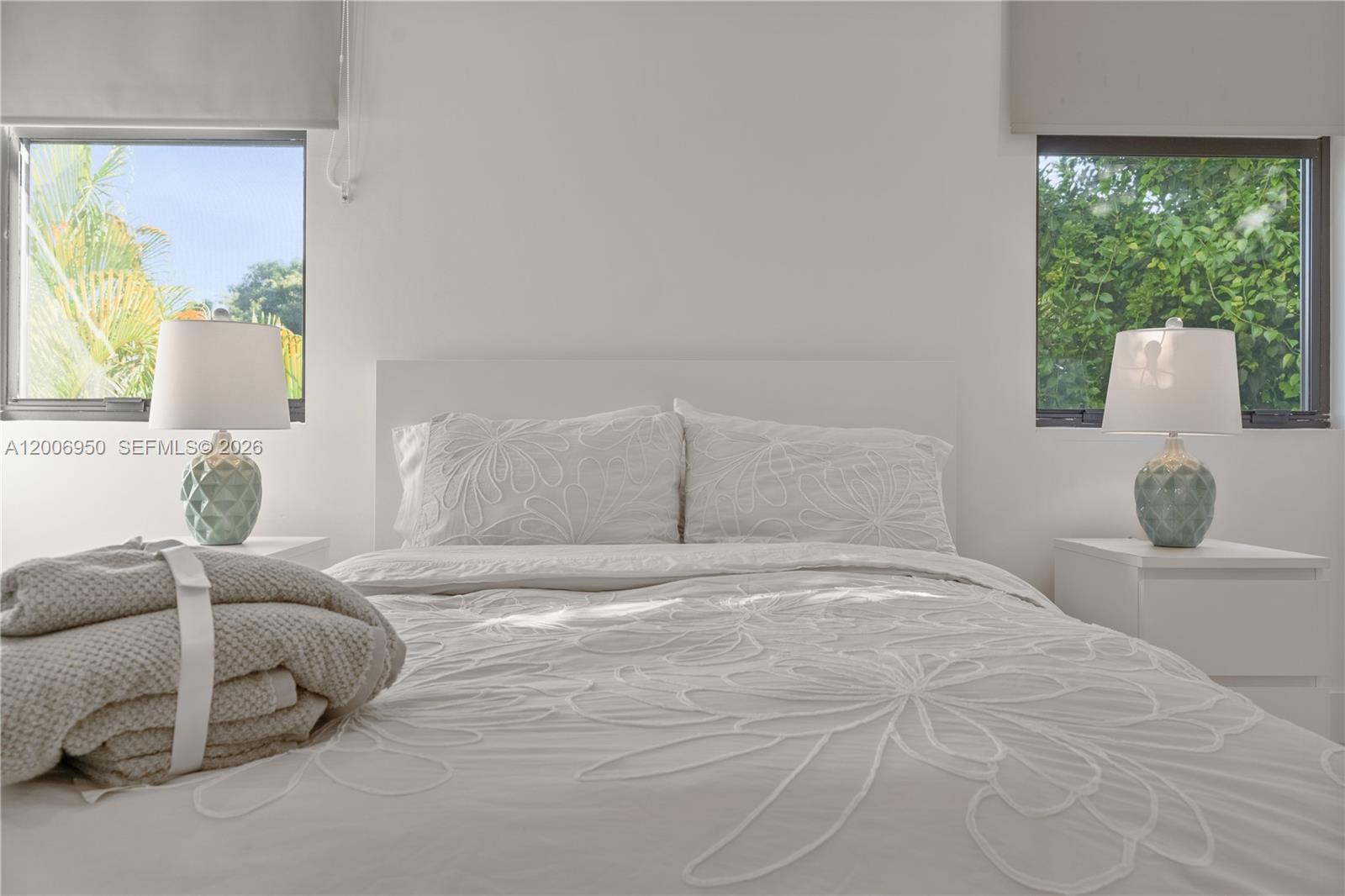 2889 Southwest 33rd Avenue, Unit 2889 Miami, FL 33133 - Photo 21 of 38 a bedroom with a large bed and a large window