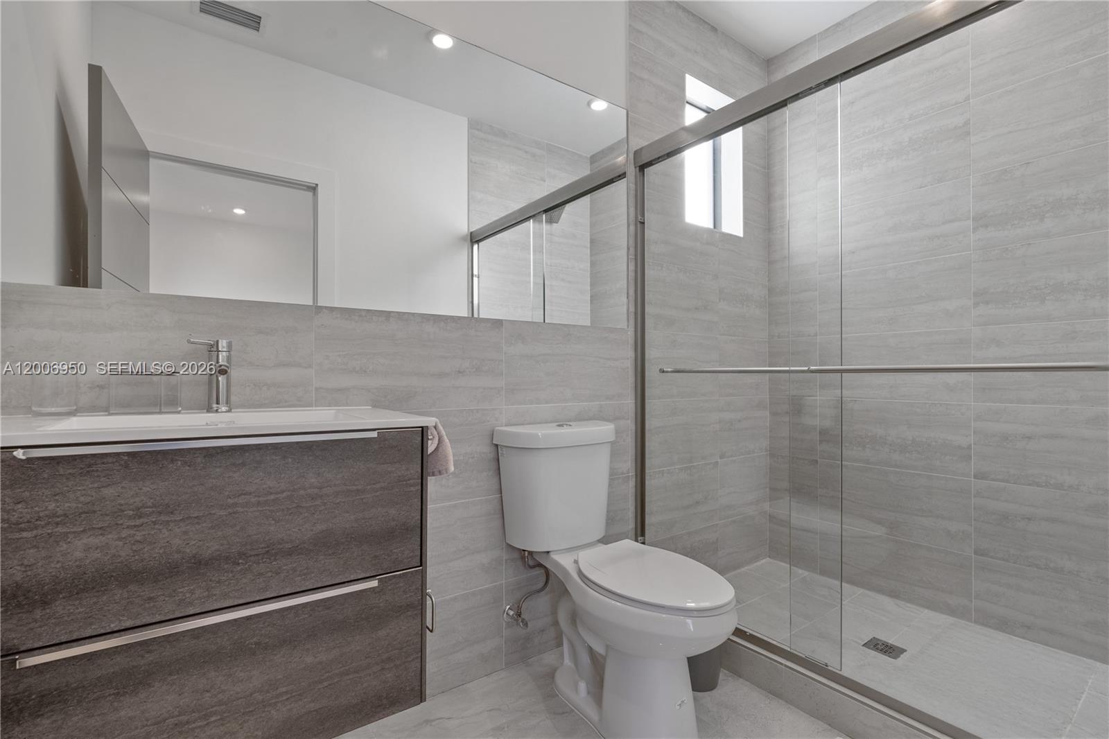 2889 Southwest 33rd Avenue, Unit 2889 Miami, FL 33133 - Photo 24 of 38 a bathroom with a sink a toilet and shower