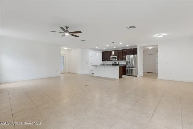 a view of a kitchen with a sink and a refrigerator
