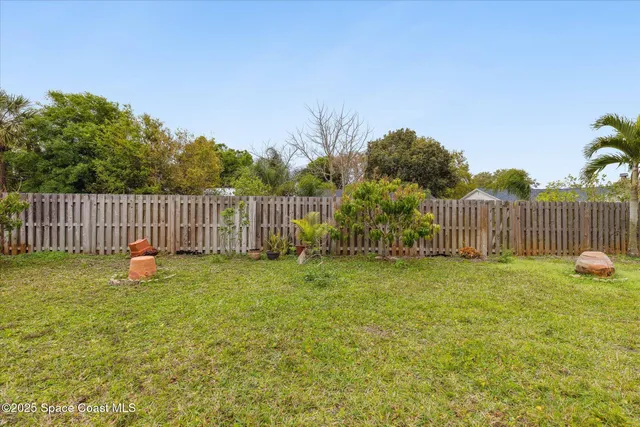 a garden with white fence