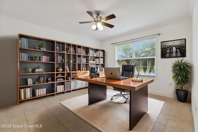 a view of a workspace with furniture and a potted plant