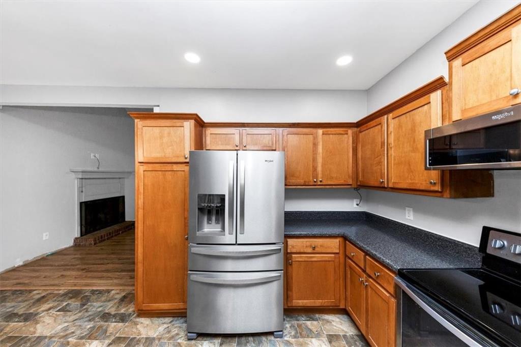 244 Freestone Lane Dallas, GA 30132 - Photo 11 of 26 a kitchen with stainless steel appliances a refrigerator and a stove top oven
