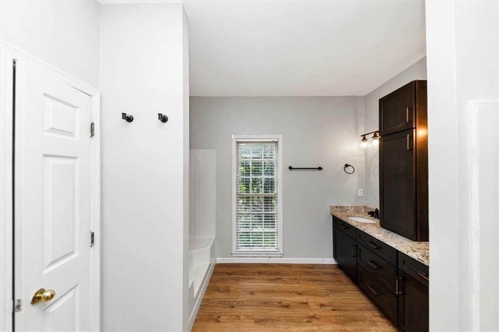 244 Freestone Lane Dallas, GA 30132 - Photo 17 of 26 a spacious bathroom with a granite countertop sink a mirror and shower