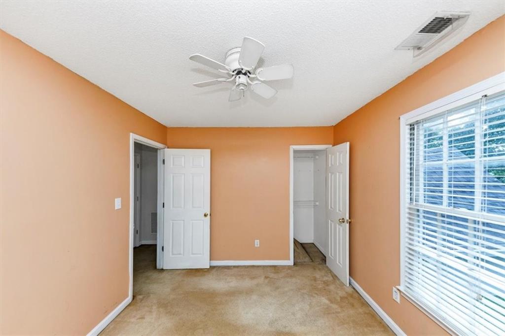 244 Freestone Lane Dallas, GA 30132 - Photo 21 of 26 an empty room with windows and fan