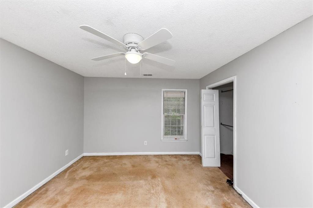244 Freestone Lane Dallas, GA 30132 - Photo 23 of 26 an empty room with windows and fan