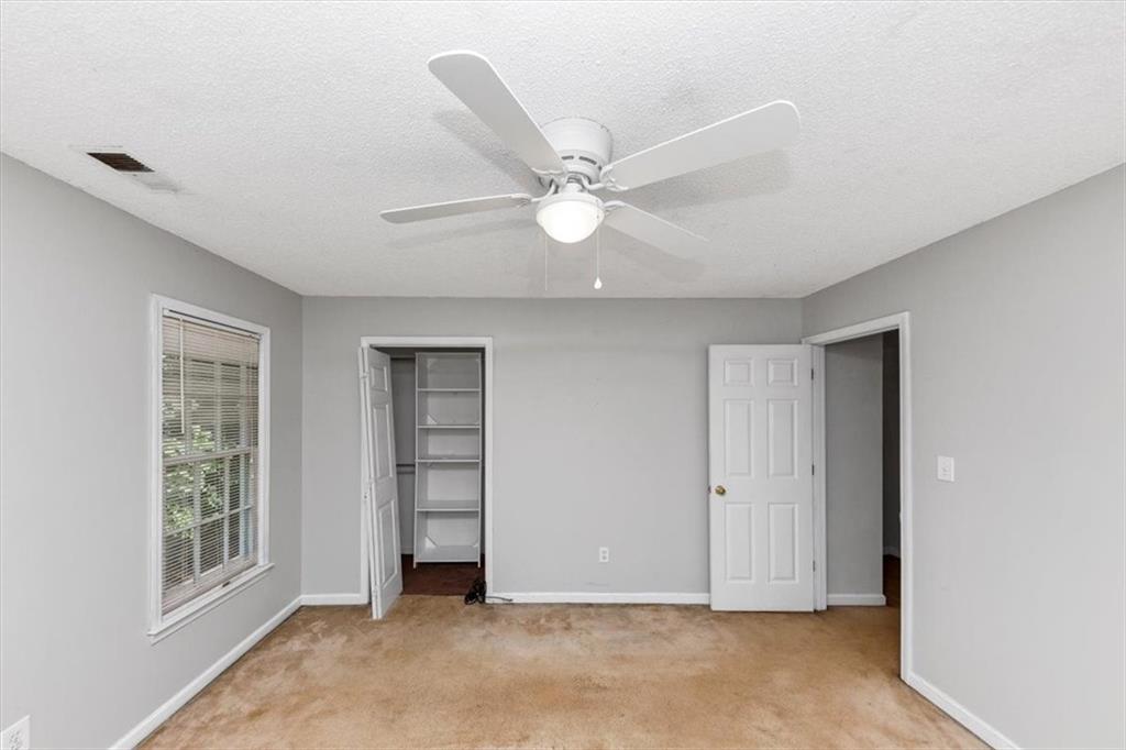 244 Freestone Lane Dallas, GA 30132 - Photo 24 of 26 an empty room with windows and fan