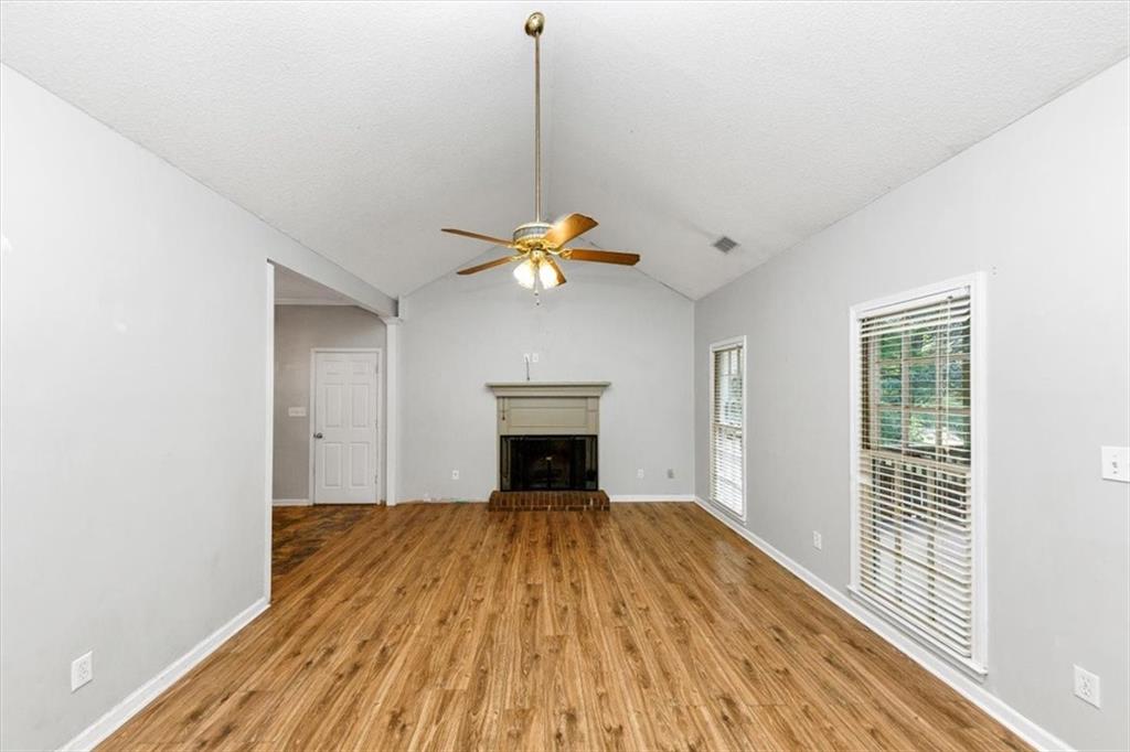 244 Freestone Lane Dallas, GA 30132 - Photo 5 of 26 a view of empty room with wooden floor and fireplace