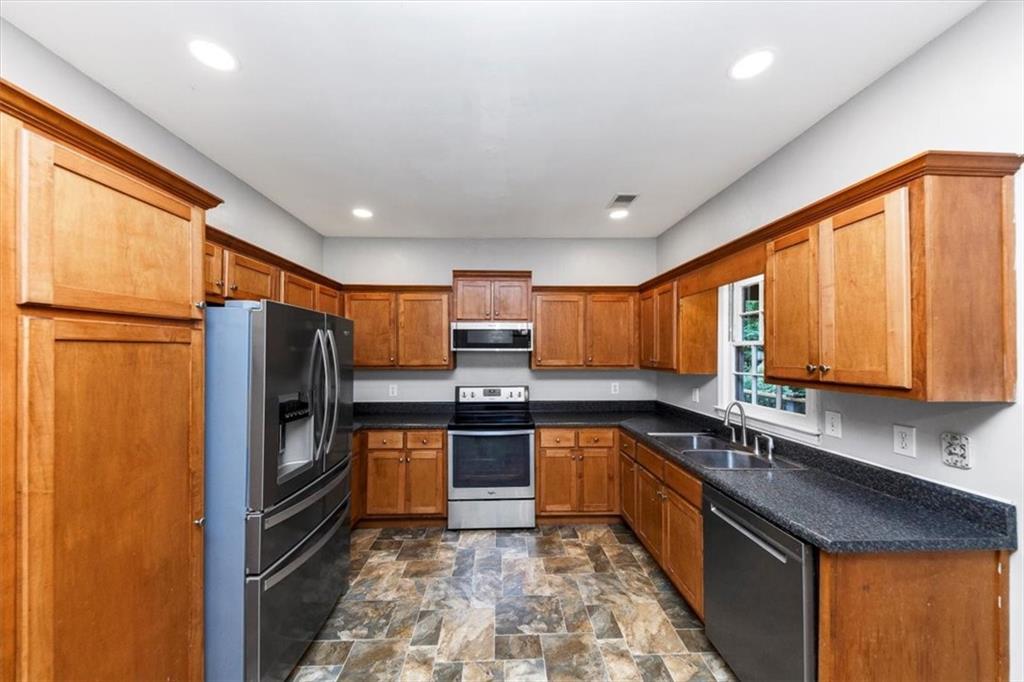 244 Freestone Lane Dallas, GA 30132 - Photo 9 of 26 a kitchen with stainless steel appliances granite countertop a refrigerator a sink dishwasher a stove top oven a refrigerator and dishwasher