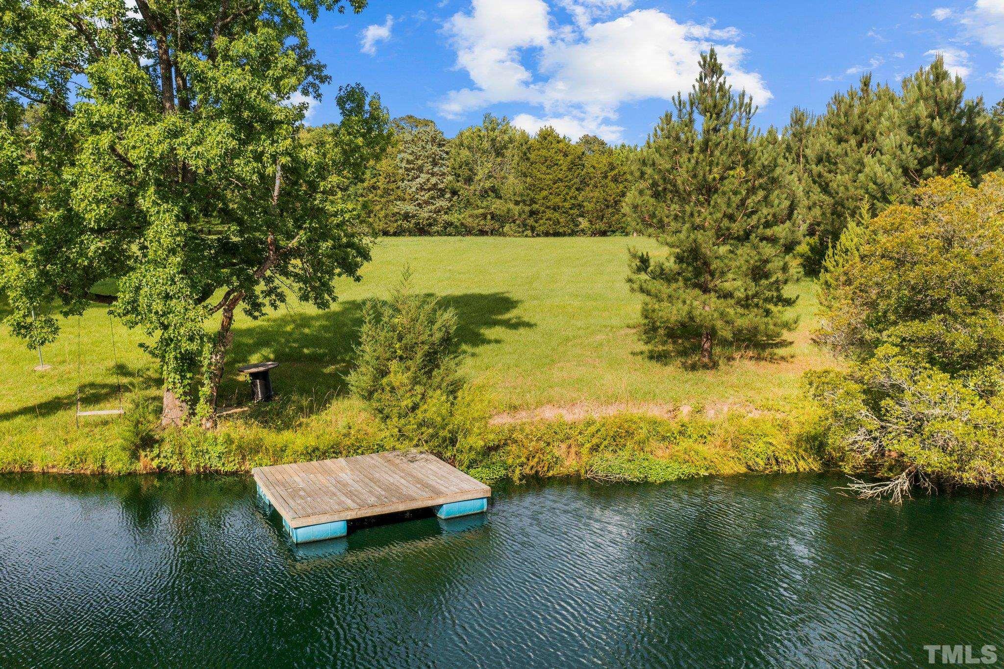 8737 Castleberry Road Apex, NC 27523 - Photo 16 of 99 a view of a lake with a trees