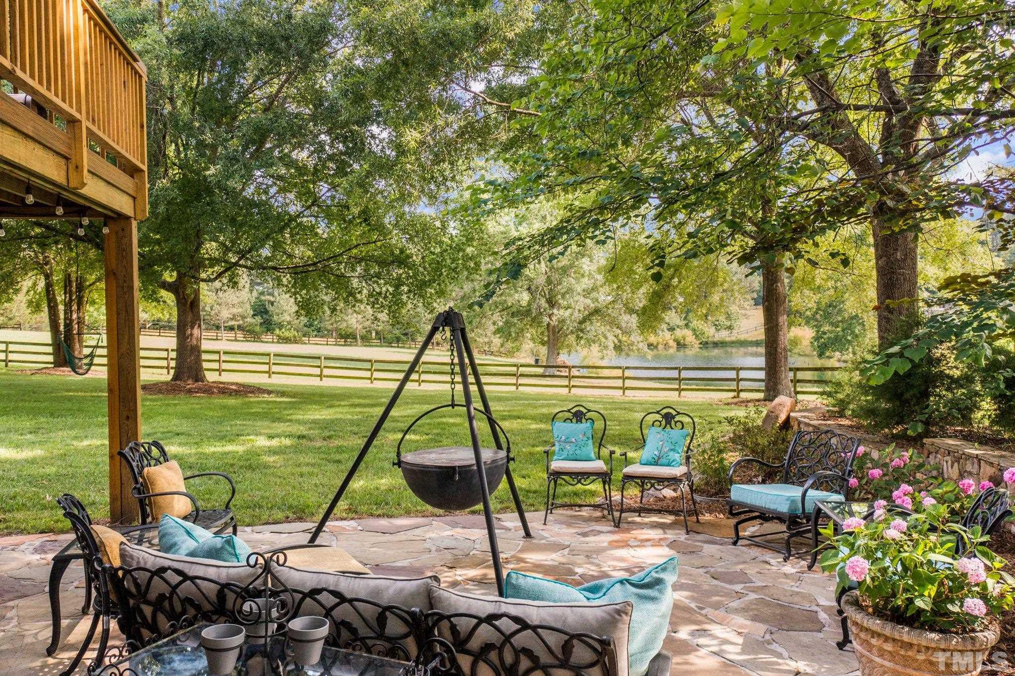8737 Castleberry Road Apex, NC 27523 - Photo 22 of 99 a view of a swimming pool with a patio and a yard