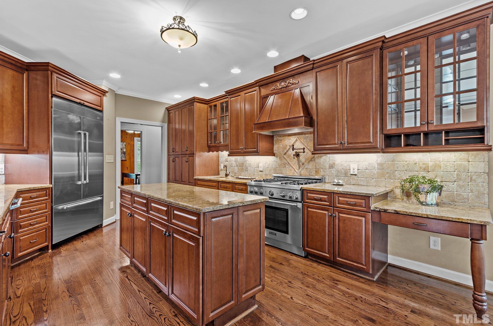 8737 Castleberry Road Apex, NC 27523 - Photo 39 of 99 a kitchen with stainless steel appliances granite countertop a stove and a sink