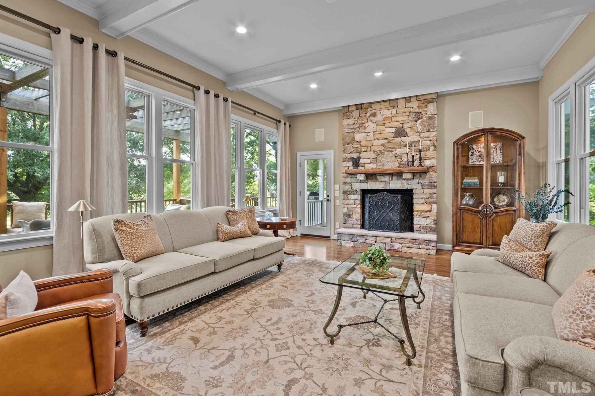 8737 Castleberry Road Apex, NC 27523 - Photo 42 of 99 a living room with furniture fireplace and a large window