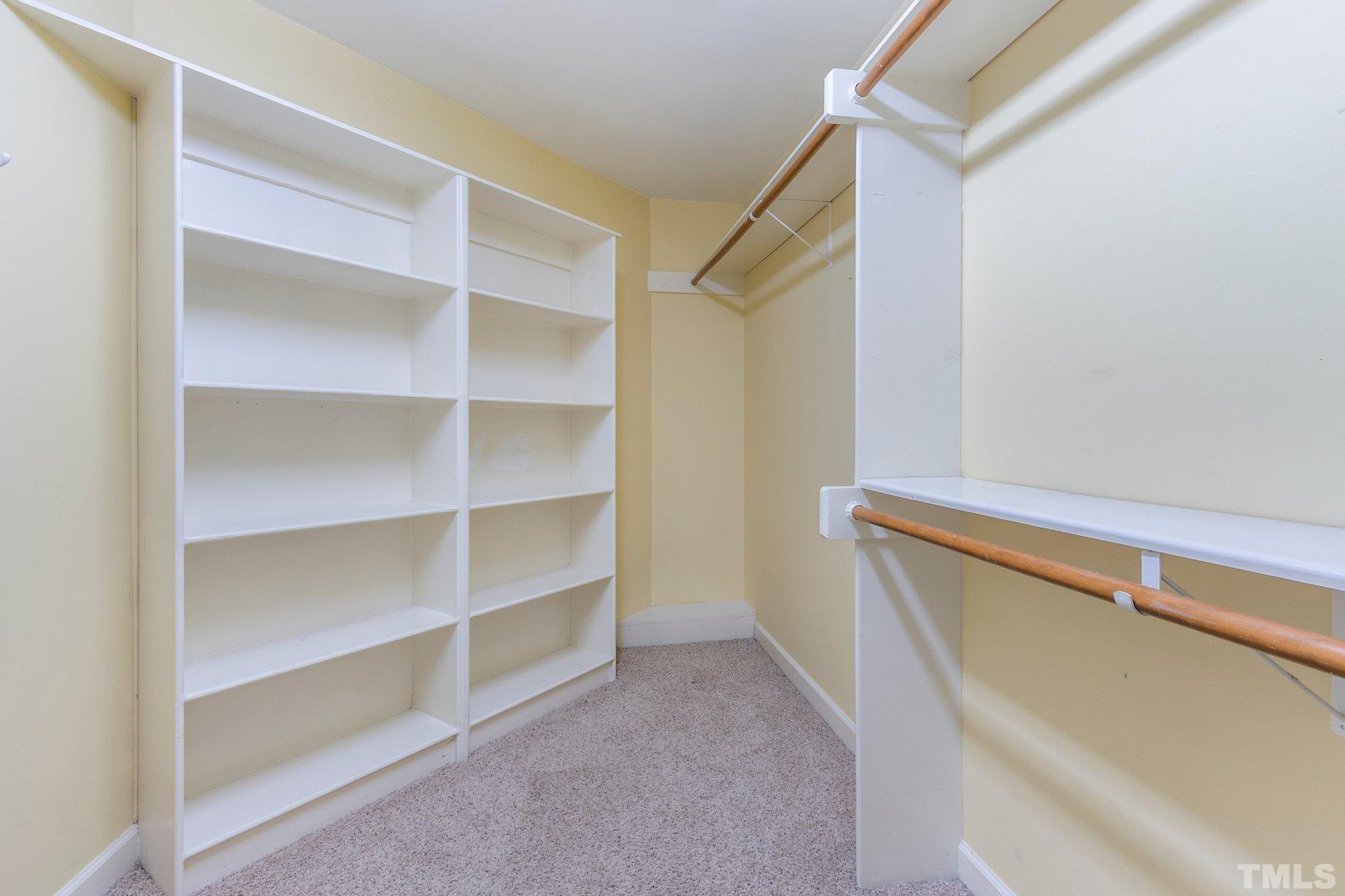 8737 Castleberry Road Apex, NC 27523 - Photo 55 of 99 a view of walk in closet with empty racks