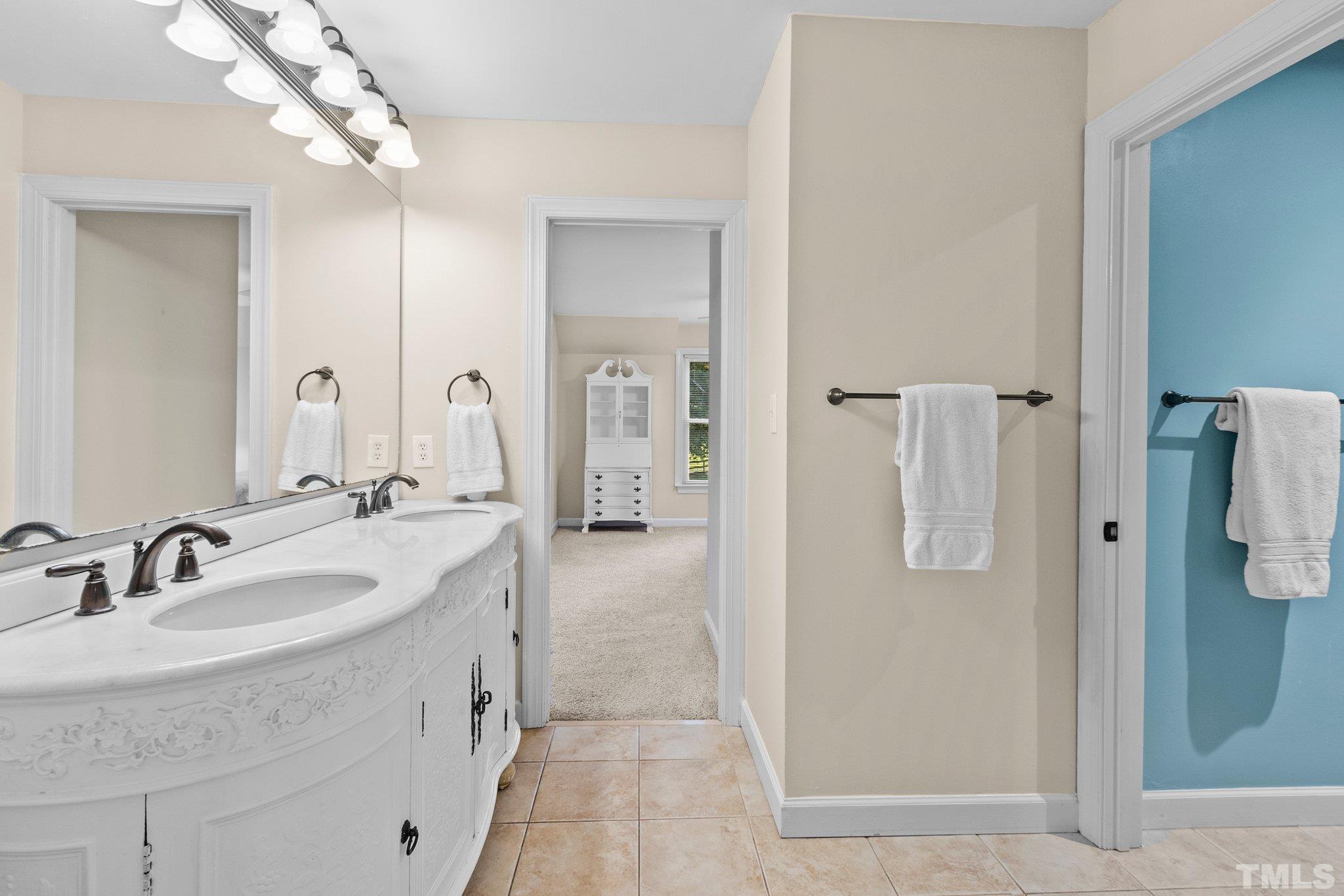 8737 Castleberry Road Apex, NC 27523 - Photo 56 of 99 a bathroom with a sink and mirror