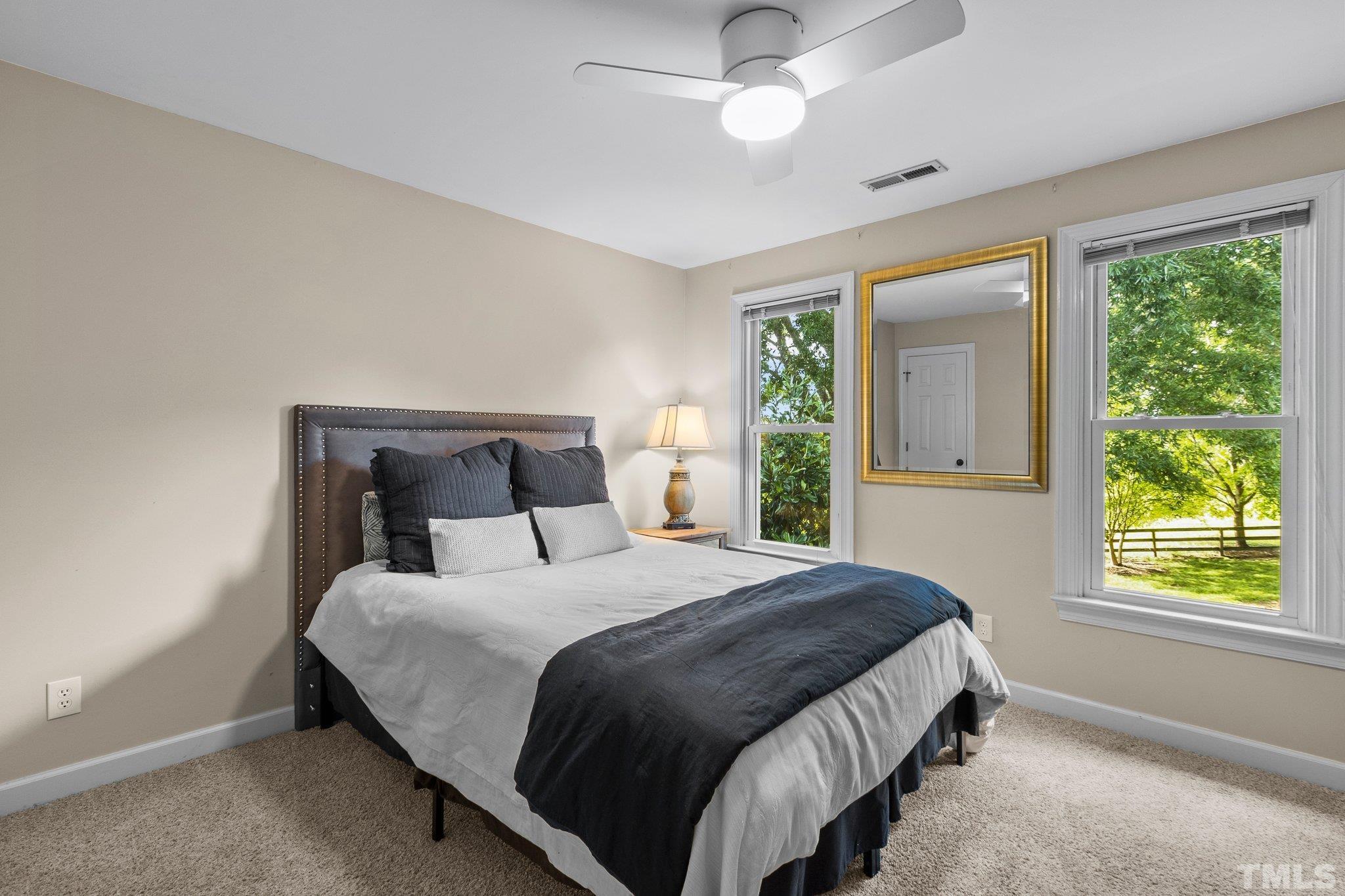 8737 Castleberry Road Apex, NC 27523 - Photo 60 of 99 a bedroom with a large bed and a window