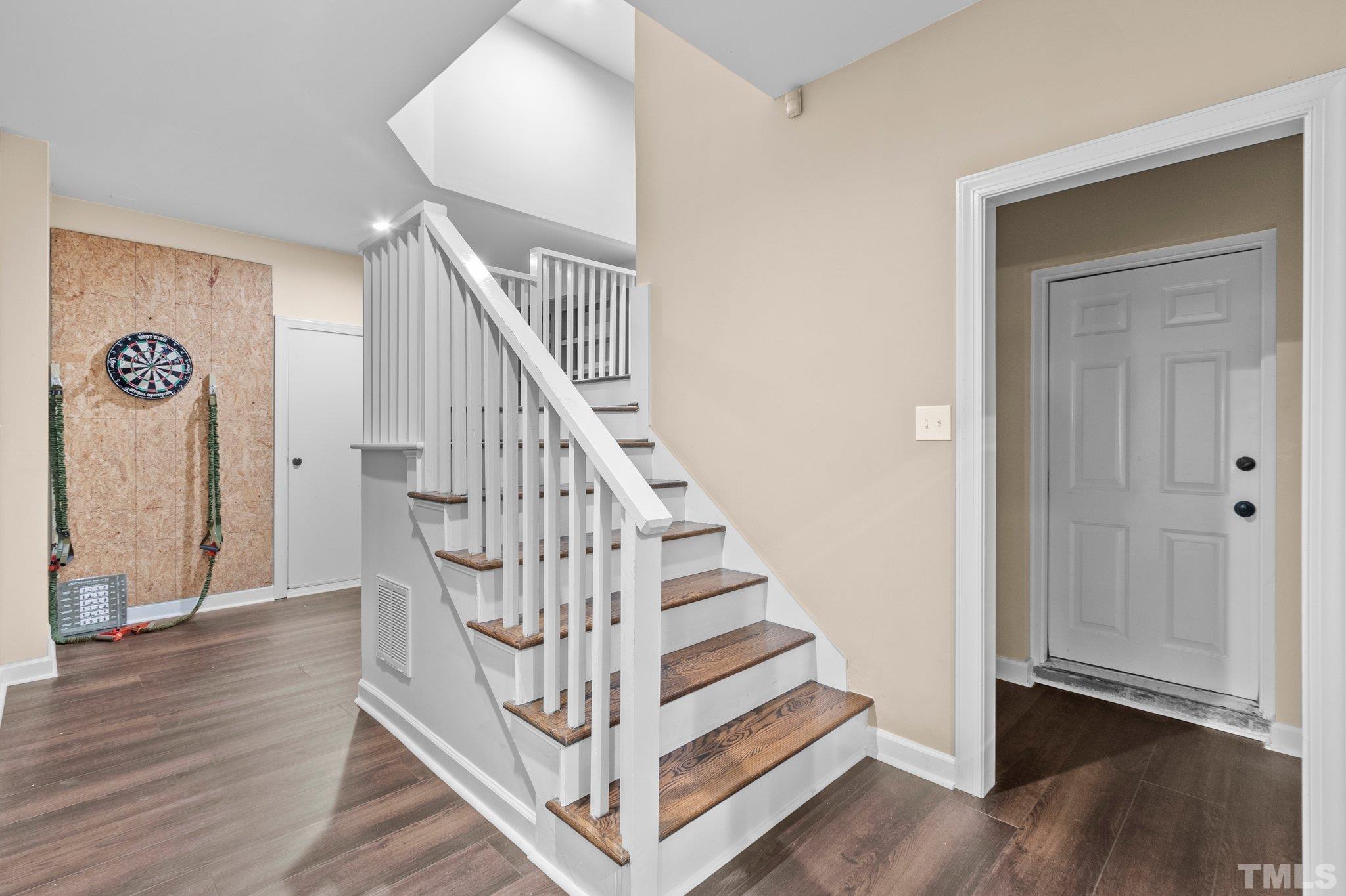 8737 Castleberry Road Apex, NC 27523 - Photo 66 of 99 a view of entryway with wooden floor and stairs