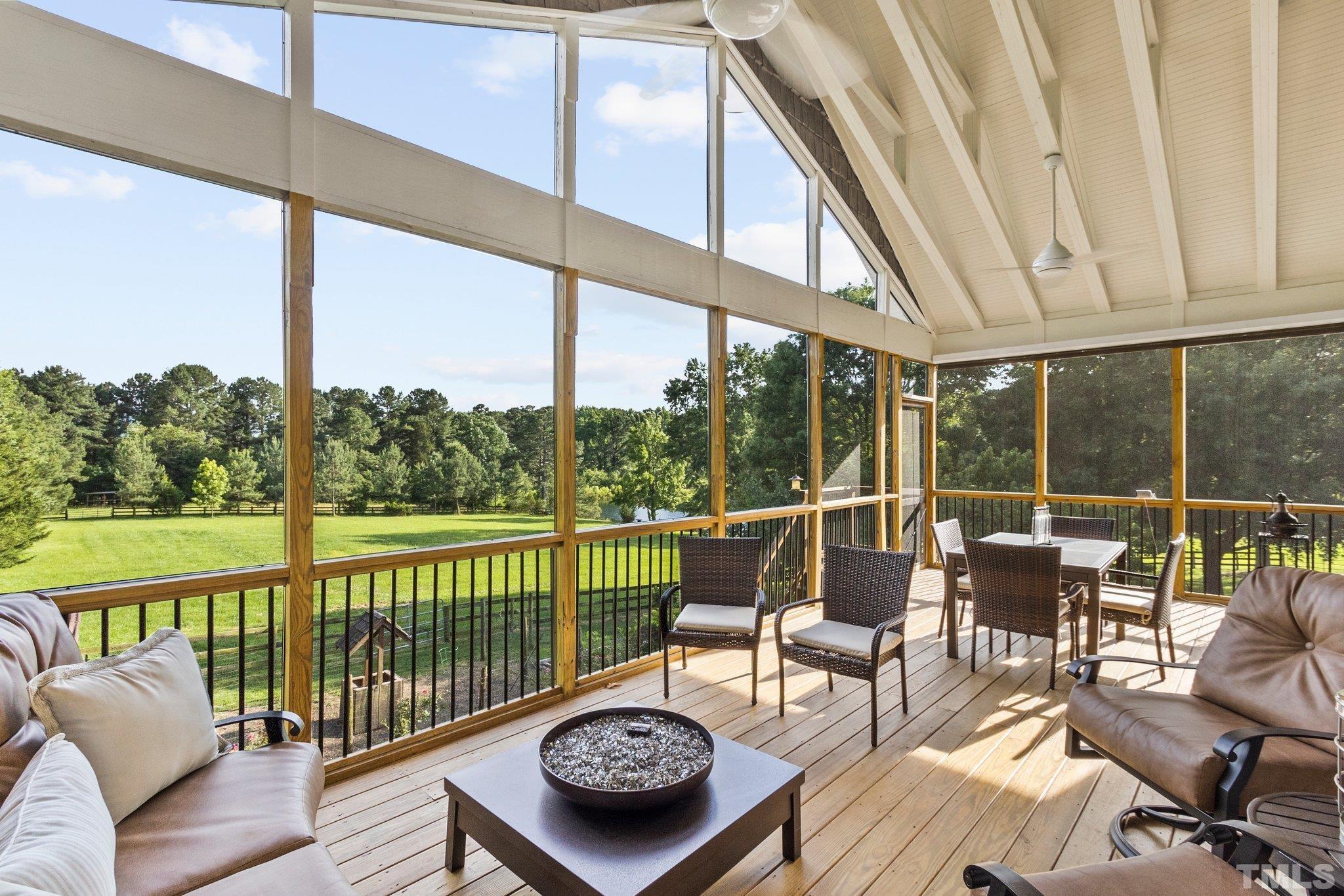 8737 Castleberry Road Apex, NC 27523 - Photo 76 of 99 a living room with furniture and a floor to ceiling window