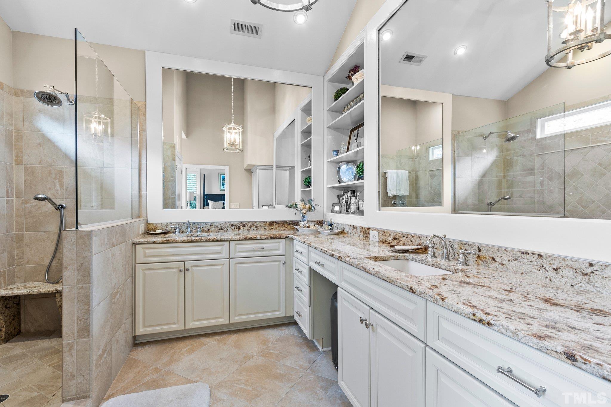 8737 Castleberry Road Apex, NC 27523 - Photo 86 of 99 a bathroom with a granite countertop sink two mirror and a shower