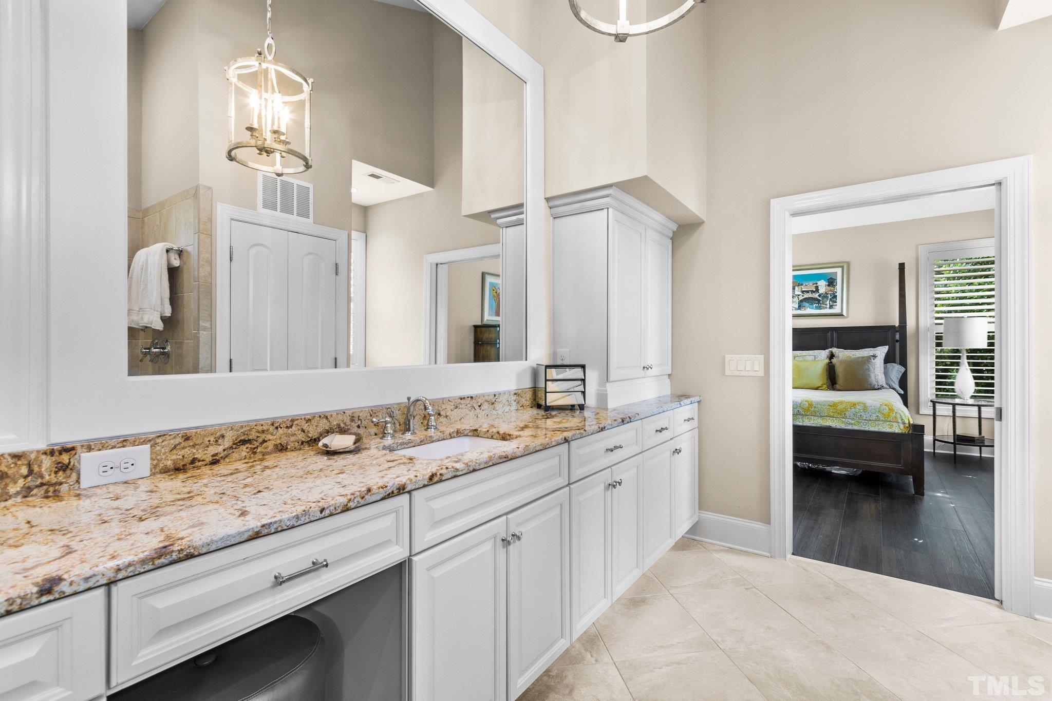 8737 Castleberry Road Apex, NC 27523 - Photo 87 of 99 a spacious en suite bathroom with double sink and a mirror