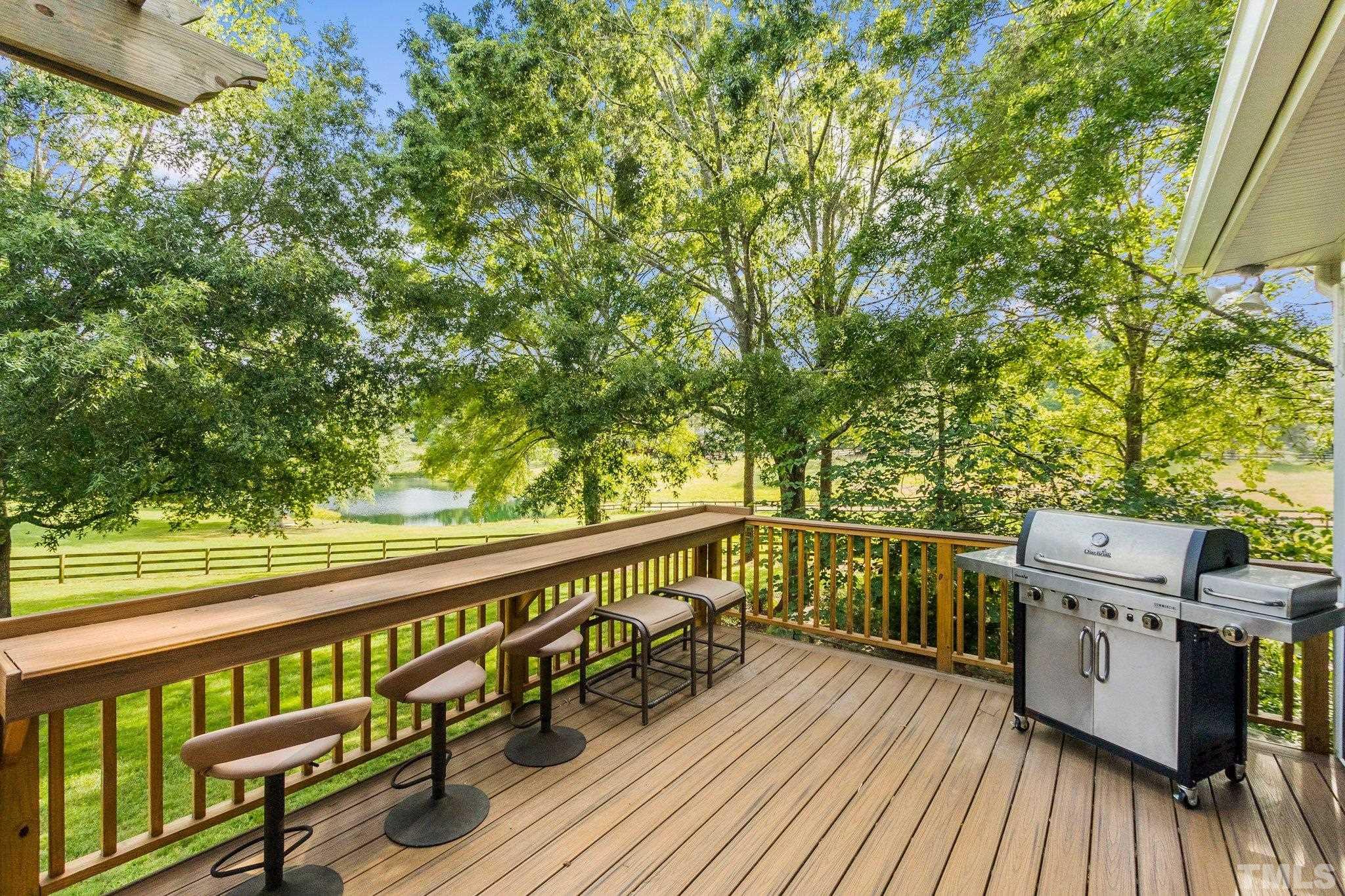 8737 Castleberry Road Apex, NC 27523 - Photo 10 of 99 a view of a balcony with wooden floor and fence