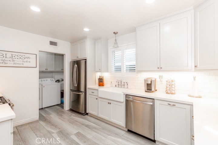 11229 Elmhurst Drive Norwalk, CA 90650 - Photo 17 of 54 a kitchen with white cabinets and refrigerator