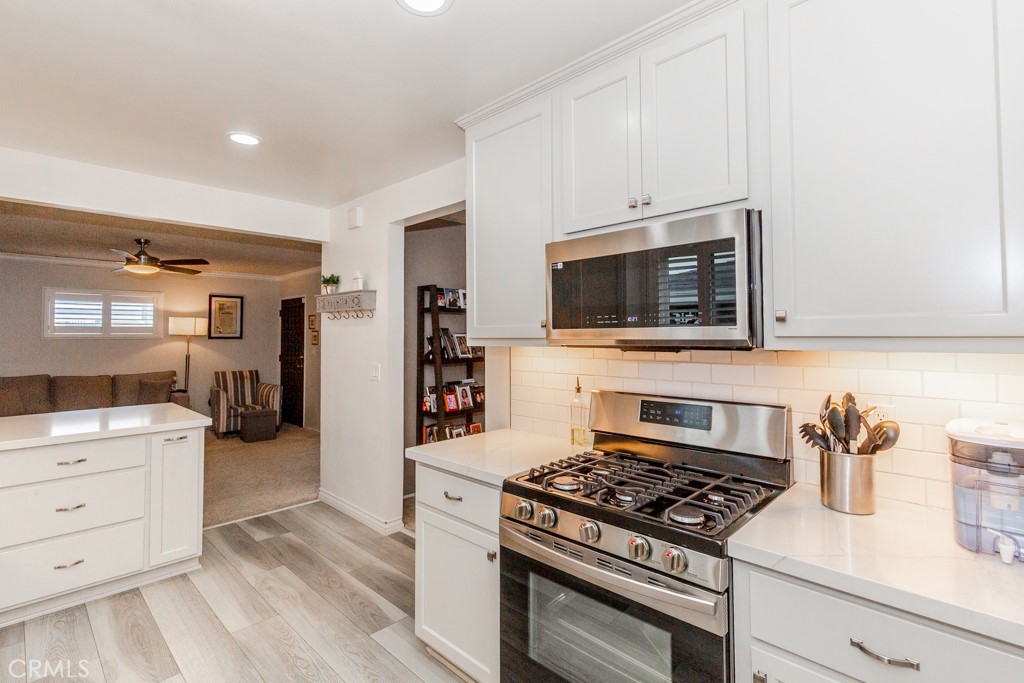 11229 Elmhurst Drive Norwalk, CA 90650 - Photo 18 of 54 a kitchen with a stove and a microwave