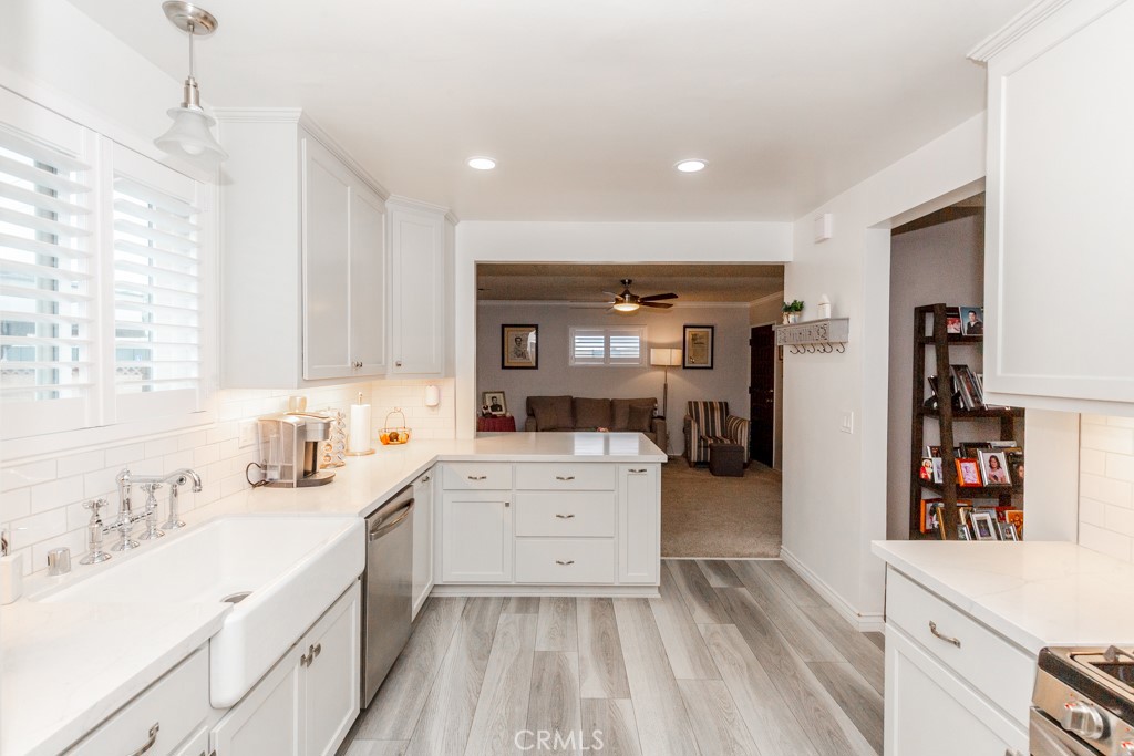 11229 Elmhurst Drive Norwalk, CA 90650 - Photo 19 of 54 a kitchen with a sink stove and cabinets