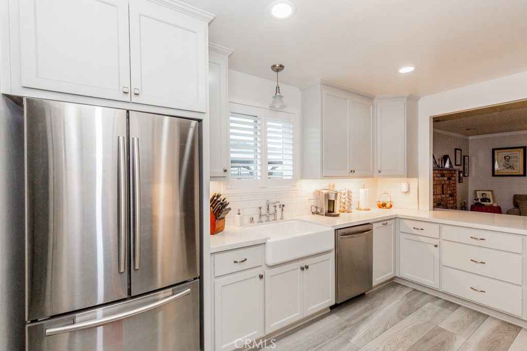 11229 Elmhurst Drive Norwalk, CA 90650 - Photo 20 of 54 a kitchen with white cabinets and white appliances