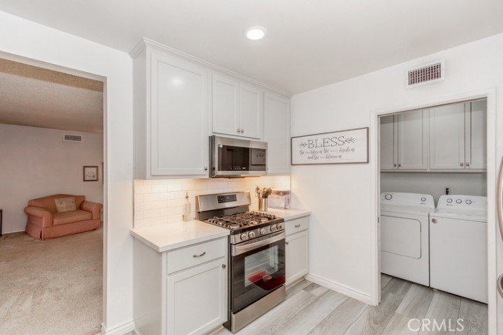 11229 Elmhurst Drive Norwalk, CA 90650 - Photo 21 of 54 a kitchen with stainless steel appliances a stove microwave and sink