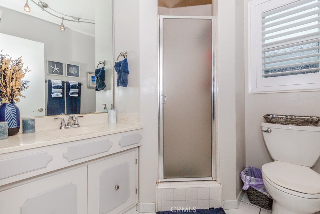 11229 Elmhurst Drive Norwalk, CA 90650 - Photo 25 of 54 a bathroom with a toilet sink and mirror