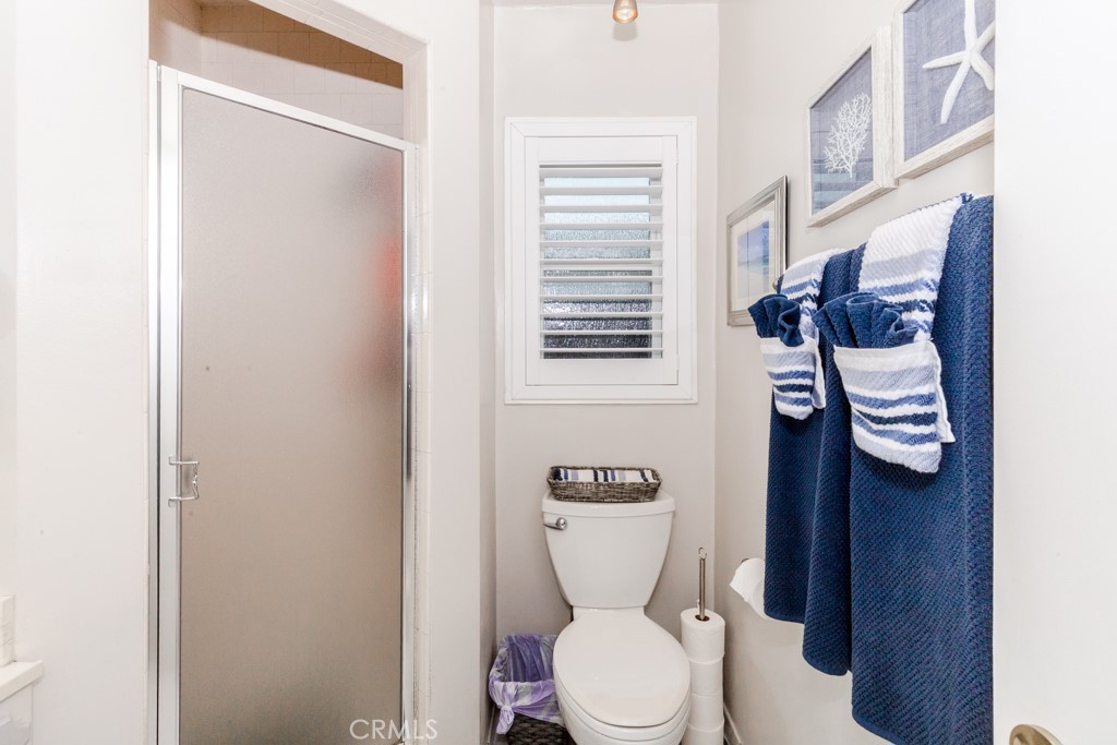11229 Elmhurst Drive Norwalk, CA 90650 - Photo 26 of 54 a white toilet sitting next to a bathroom sink and vanity