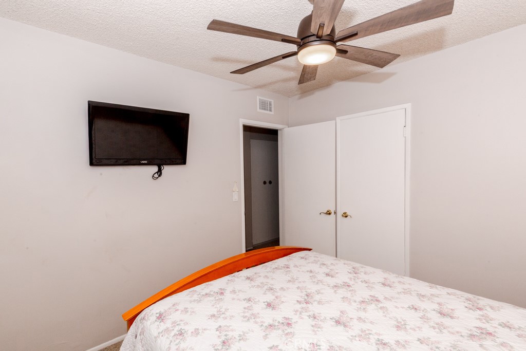 11229 Elmhurst Drive Norwalk, CA 90650 - Photo 29 of 54 a bedroom with a bed and a flat screen tv