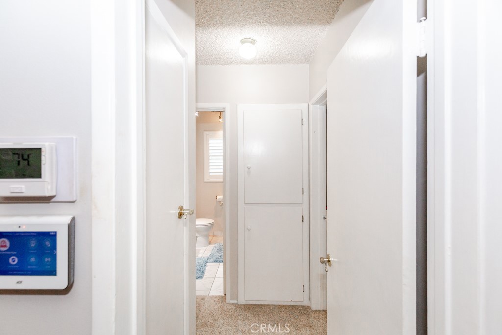 11229 Elmhurst Drive Norwalk, CA 90650 - Photo 32 of 54 a view of a hallway with wooden floor