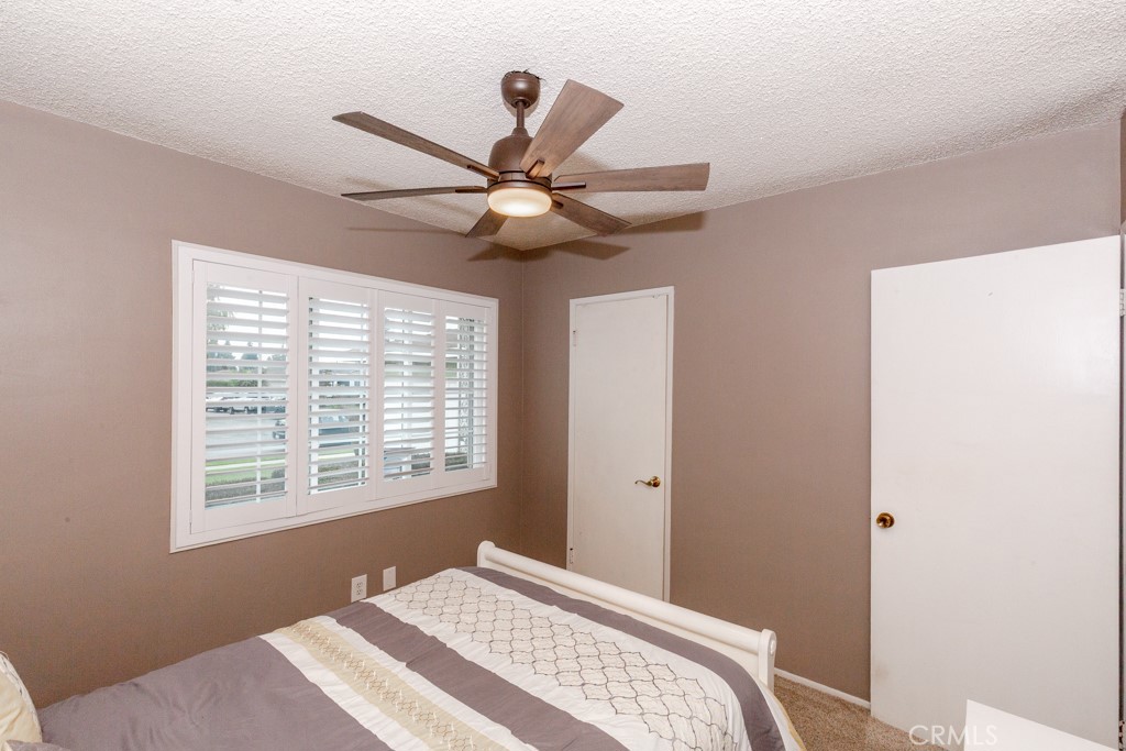 11229 Elmhurst Drive Norwalk, CA 90650 - Photo 34 of 54 a bedroom with a large bed and a window