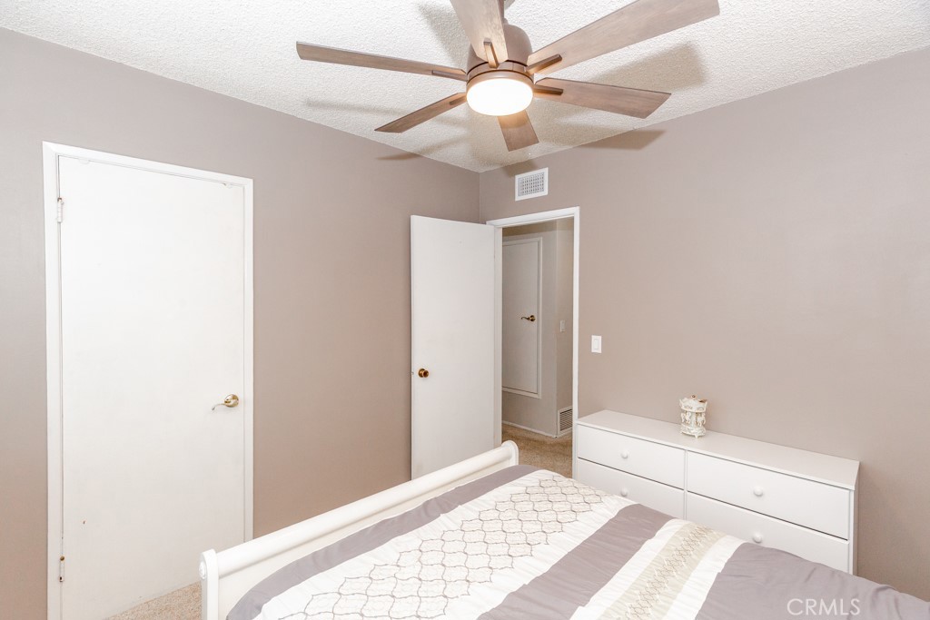 11229 Elmhurst Drive Norwalk, CA 90650 - Photo 35 of 54 a bedroom with a bed and a chandelier