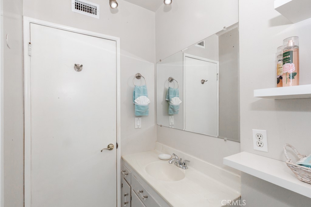 11229 Elmhurst Drive Norwalk, CA 90650 - Photo 37 of 54 a bathroom with a sink and a mirror