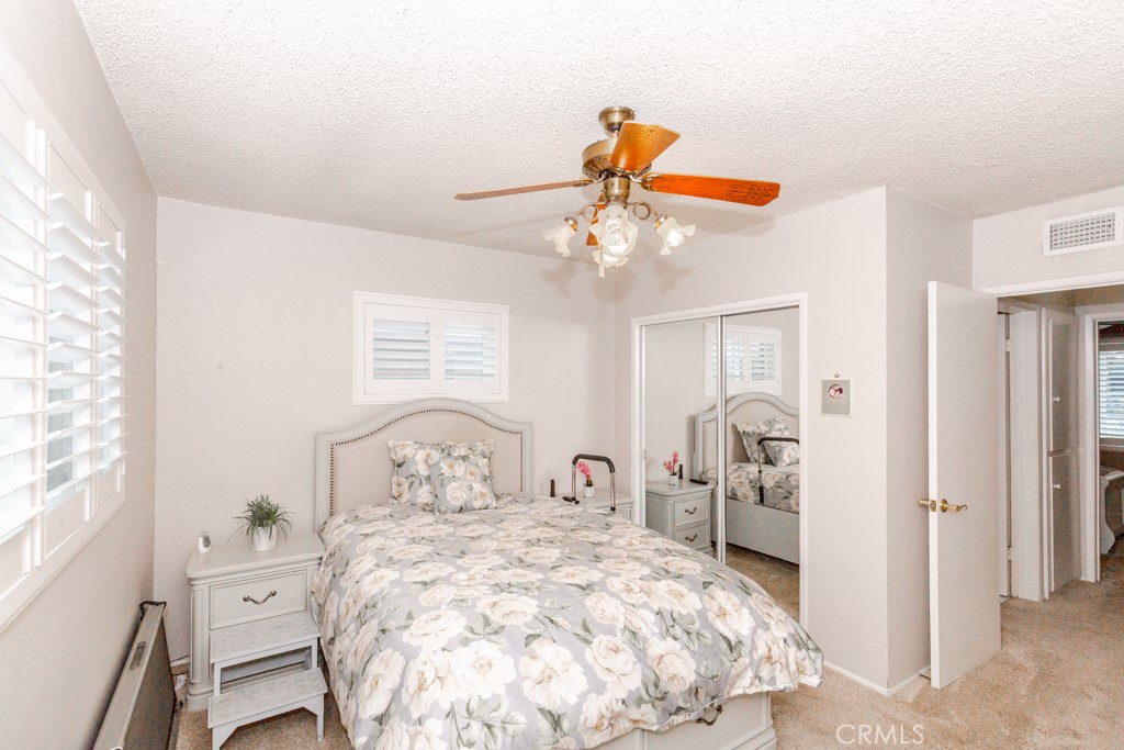 11229 Elmhurst Drive Norwalk, CA 90650 - Photo 40 of 54 a bedroom with a bed and a chandelier