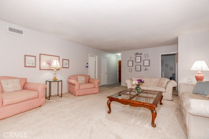 11229 Elmhurst Drive Norwalk, CA 90650 - Photo 5 of 54 a living room with furniture and a table