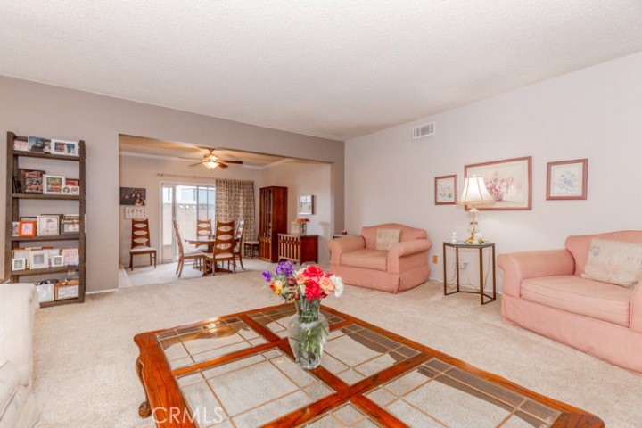 11229 Elmhurst Drive Norwalk, CA 90650 - Photo 6 of 54 a living room with furniture and white walls