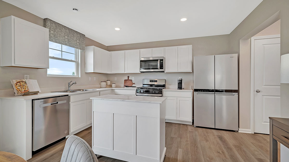 6719 Applegate Drive Plainfield, IL 60586 - Photo 27 of 39 a kitchen with cabinets stainless steel appliances a sink and a window