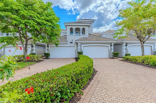 a front view of a house with a yard and a garage