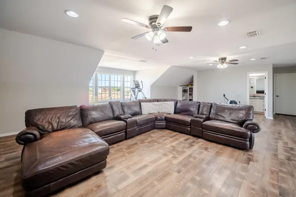 a bed room with a bed and a ceiling fan