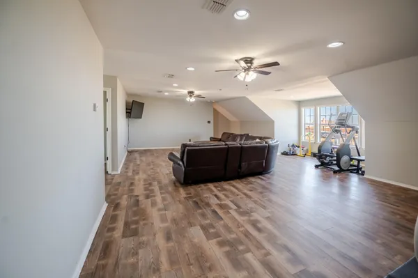 a spacious bedroom with a bed and a chandelier