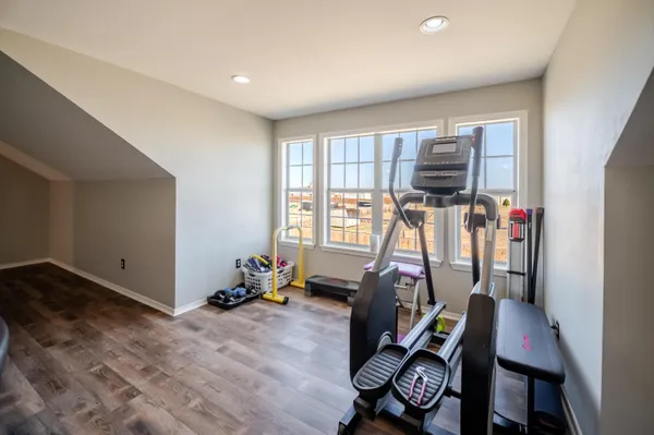 a living room with a fireplace and a floor to ceiling window