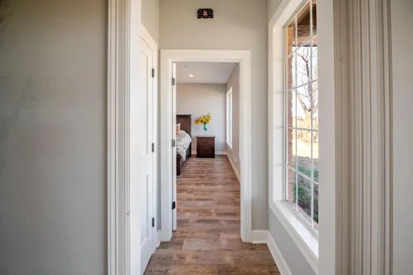 a kitchen with stainless steel appliances granite countertop a stove top oven a sink dishwasher and white cabinets with wooden floor