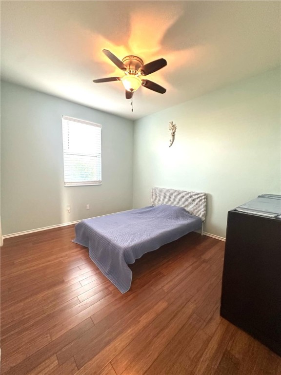 15517 Dyna Street Corpus Christi, TX 78418 - Photo 14 of 16 a bedroom with a bed and wooden floor