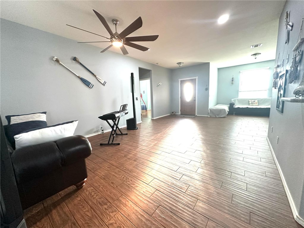 15517 Dyna Street Corpus Christi, TX 78418 - Photo 2 of 16 a living room with furniture and a wooden floor