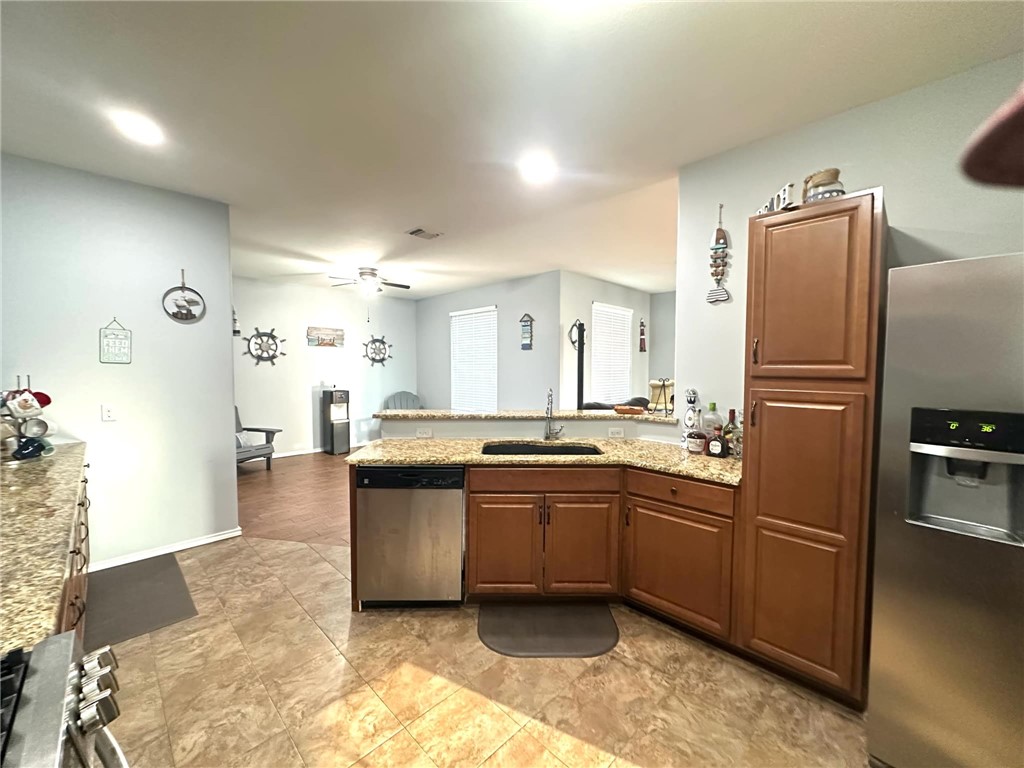 15517 Dyna Street Corpus Christi, TX 78418 - Photo 7 of 16 a large kitchen with a large counter top sink and stainless steel appliances