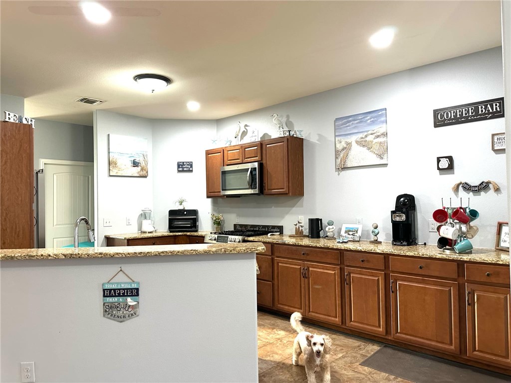 15517 Dyna Street Corpus Christi, TX 78418 - Photo 10 of 16 a kitchen with a sink cabinets and window