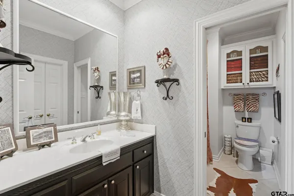 a bedroom with a bed dresser and a flat tv screen